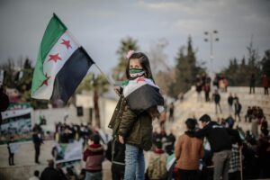 Photo by Ahmed akacha: https://www.pexels.com/photo/portrait-of-girl-holding-syria-flag-10629491/